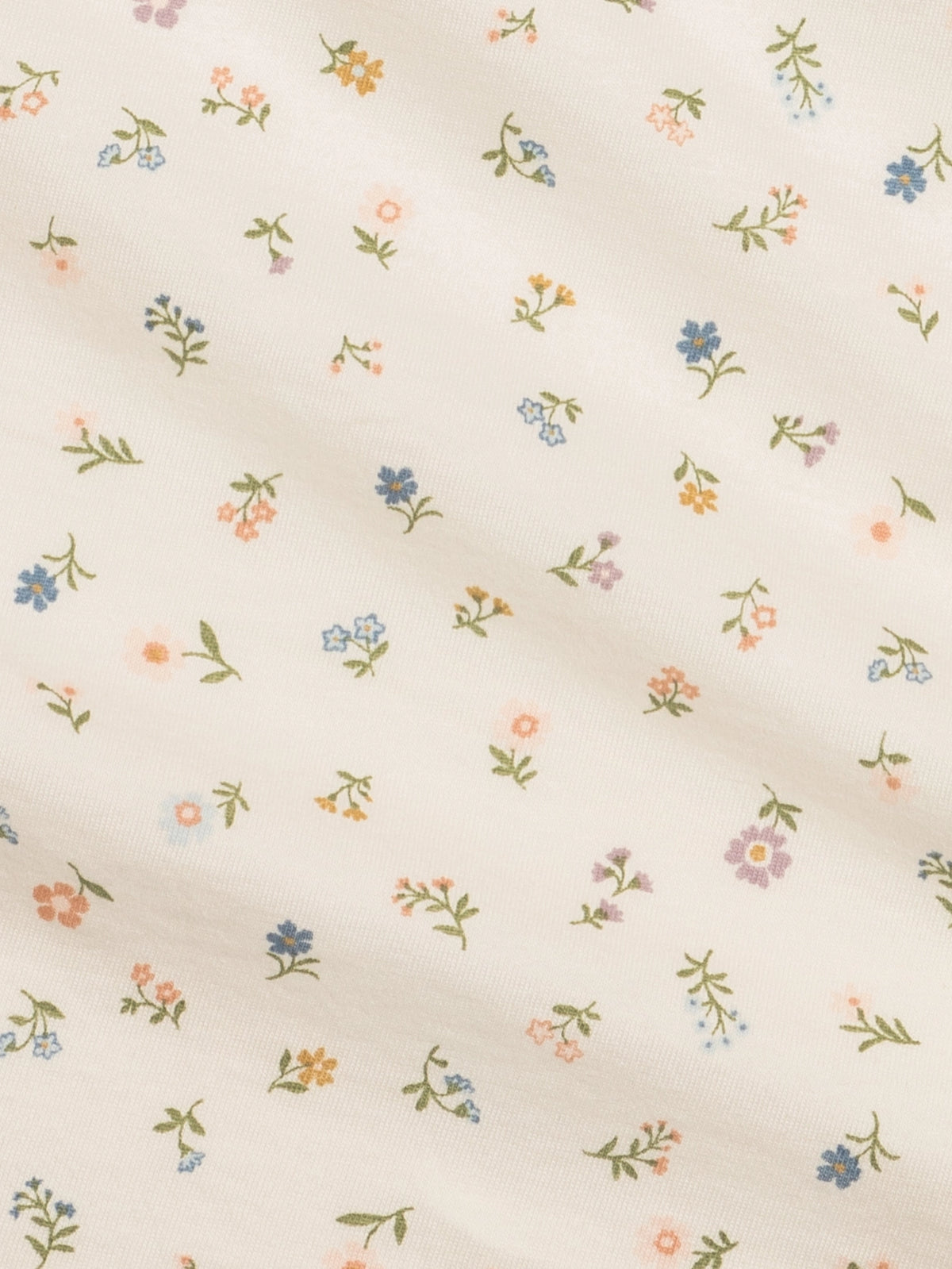 Close-up of the colorful Petaline Floral print on an organic cotton swaddle blanket.