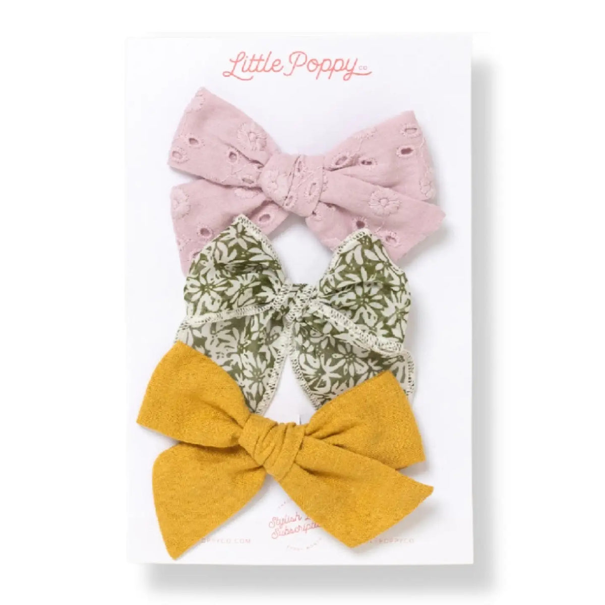 Three bow clips in dusty pink, olive floral, and mustard by Little Poppy Co.