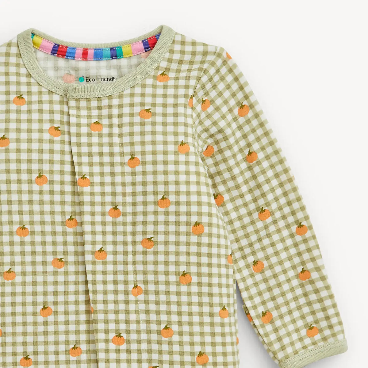 Close-up of the green gingham and orange pumpkin print on the Magnetic Me modal footie.