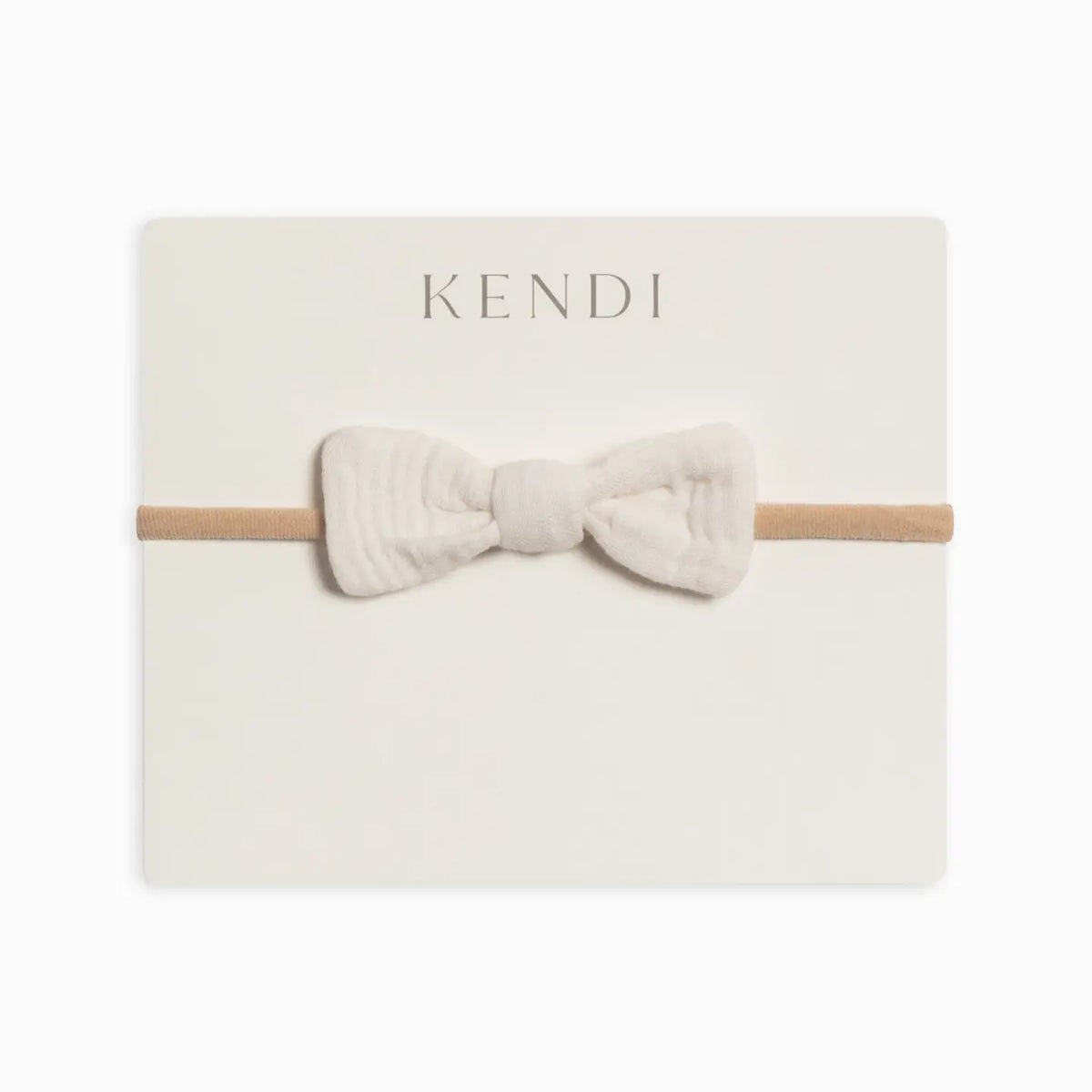 Colored Organics Classic Muslin Dainty Bow in Ivory on a soft nylon baby headband.