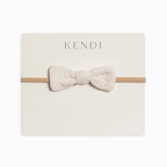 Colored Organics Classic Muslin Dainty Bow in Ivory on a soft nylon baby headband.