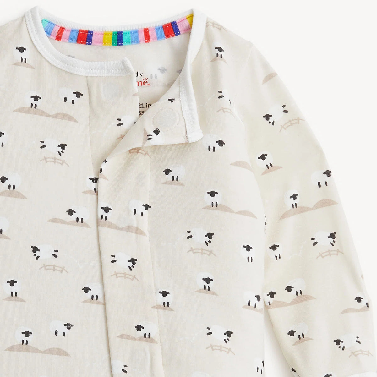 Close-up of Baa Baa Baby modal footie neckline, sheep print and magnetic closure.