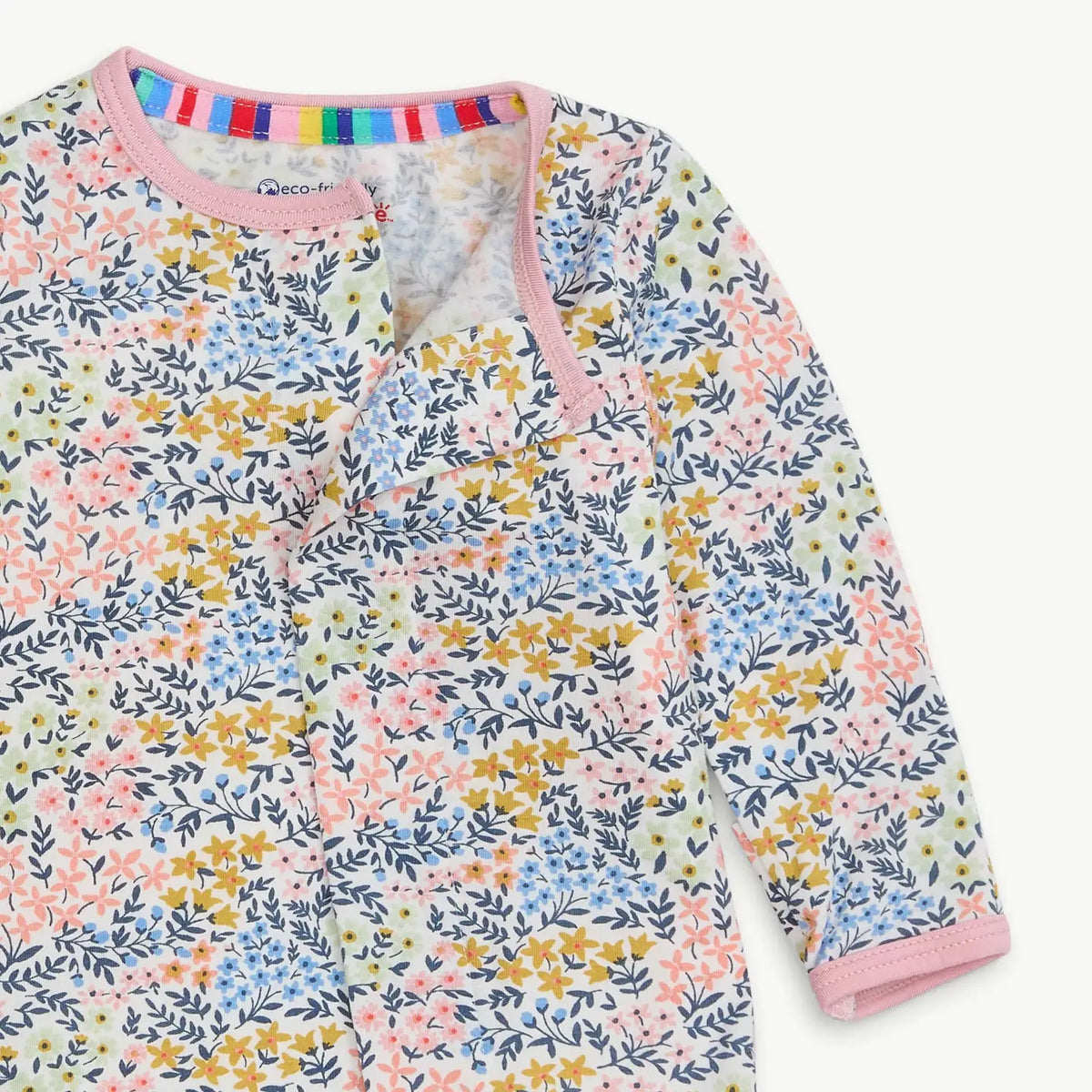 Close-up of the hidden magnetic closure and pink ruffle trim on the Chelsea floral modal footie.